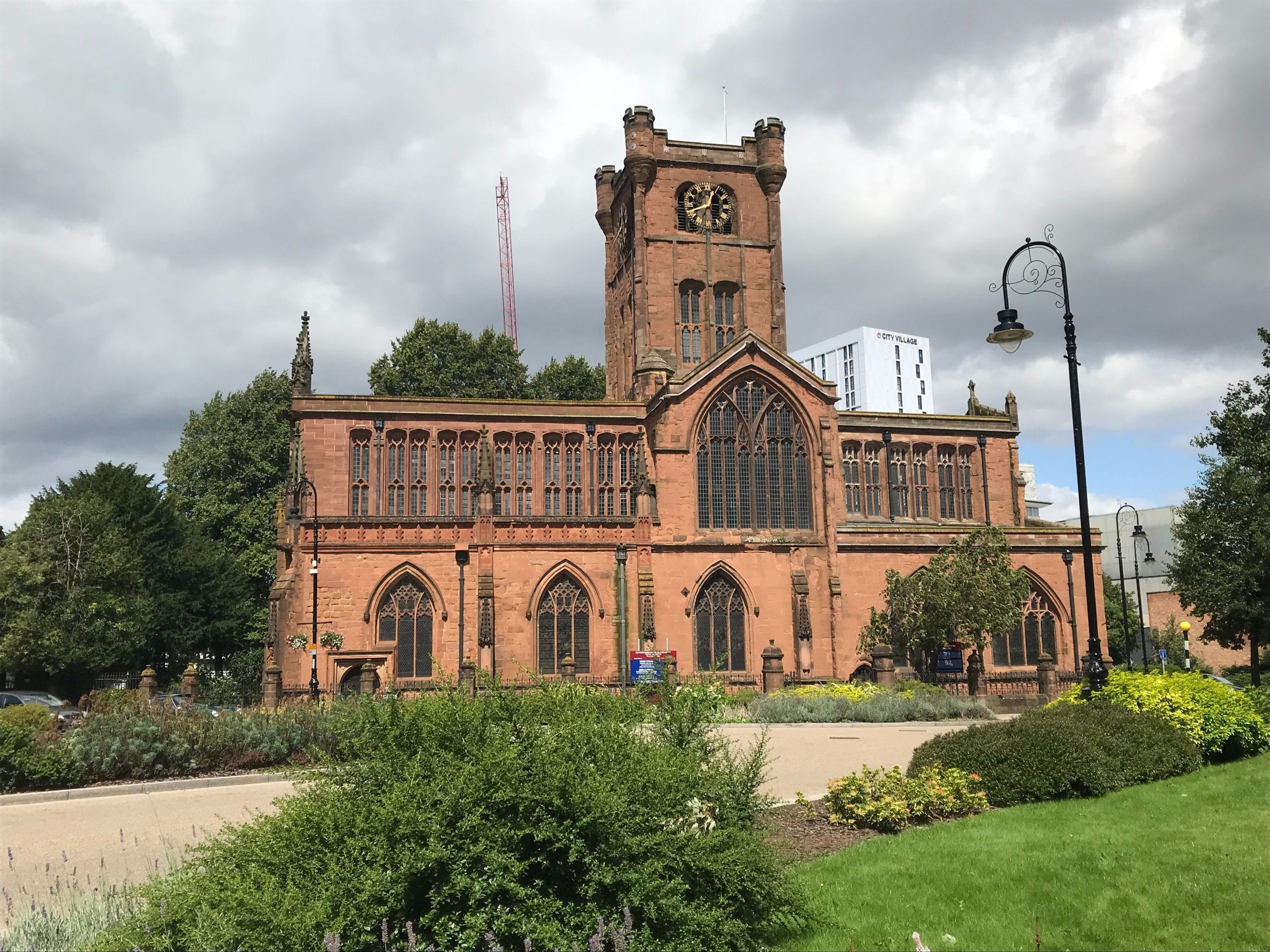 St John the Baptist church in Coventry photographed on a cloudy day.