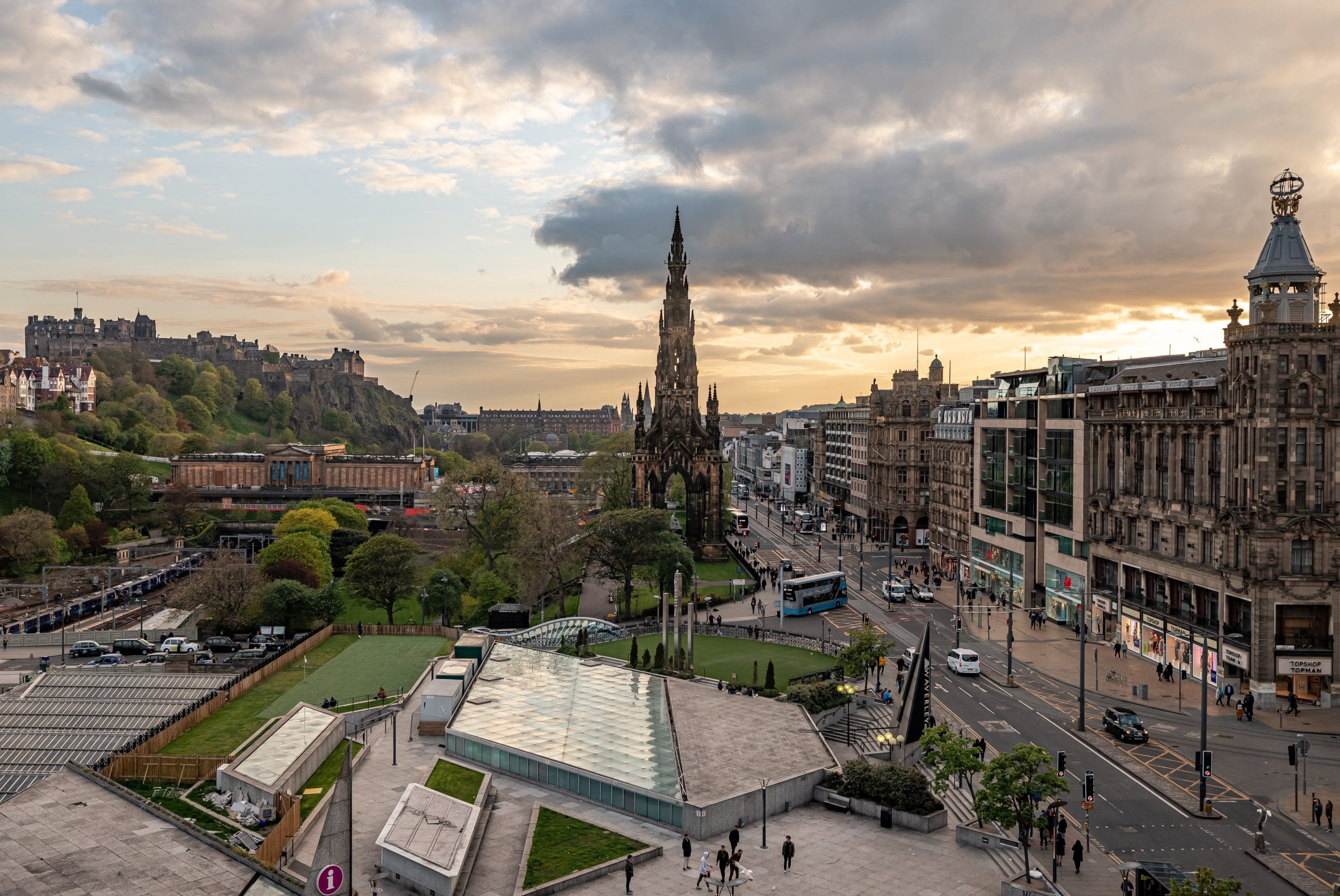 Edinburgh city centre from above with the castle on the left hand side, Scott Monument in the middle and Princes street shops on the right.