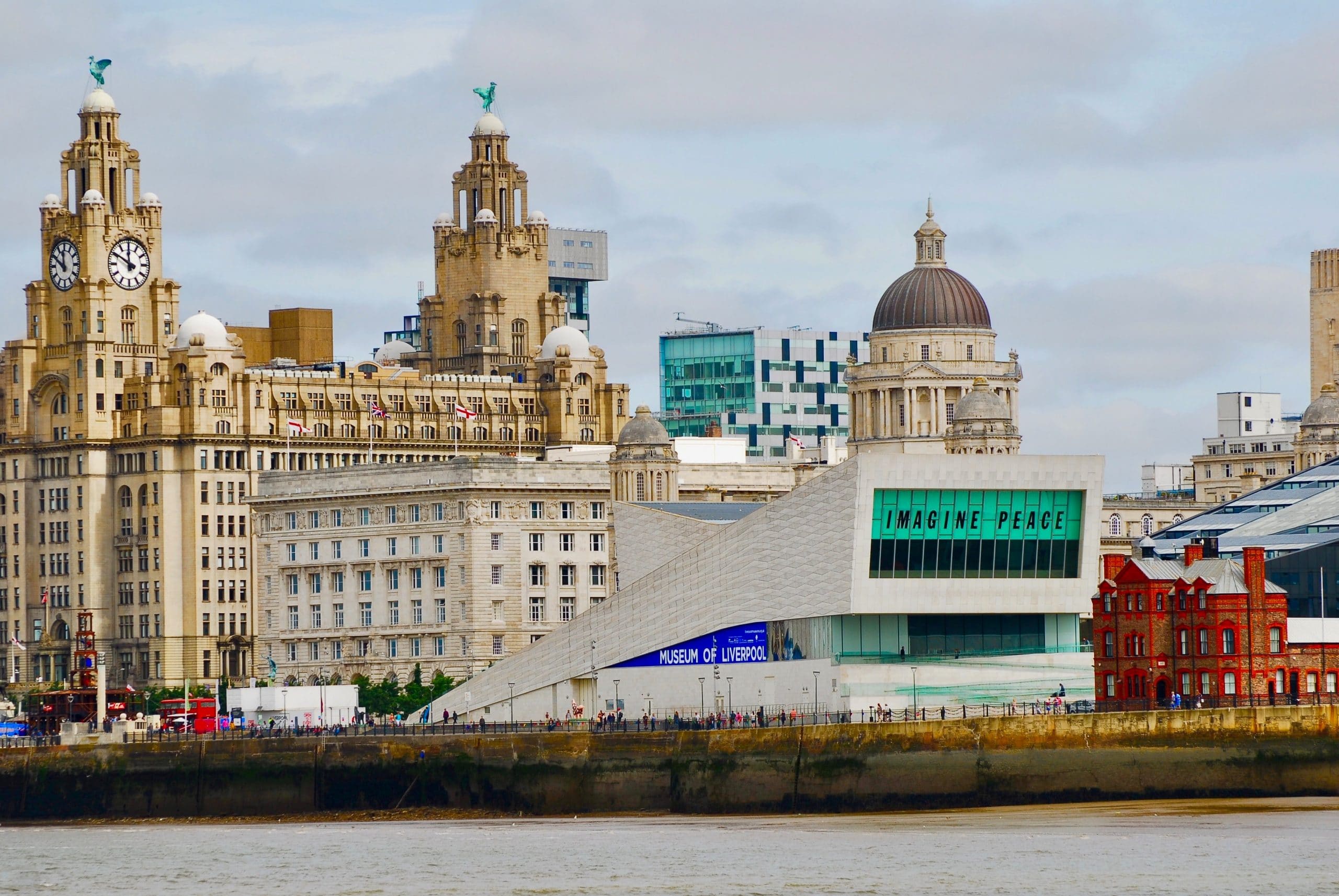 Liverpool waterfront on a cloudy day with the Liver building and Museum of Liverpool in the background.