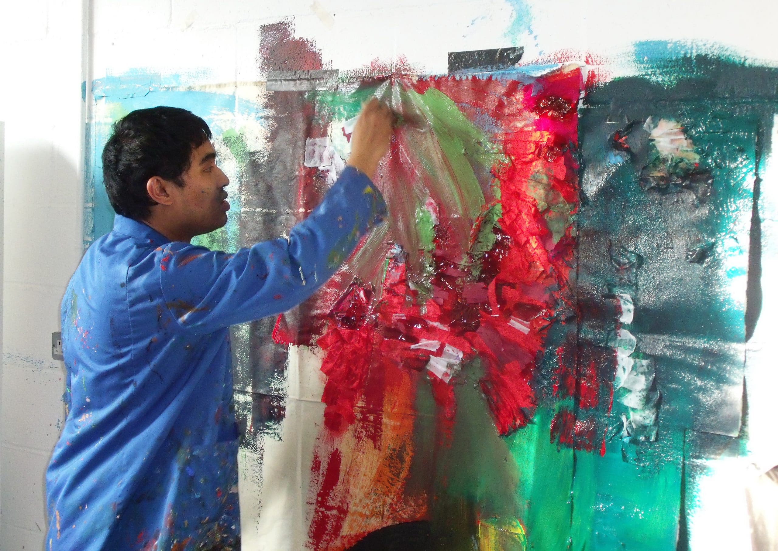 An ActionSpace artist creating colourful artwork in their London studio.