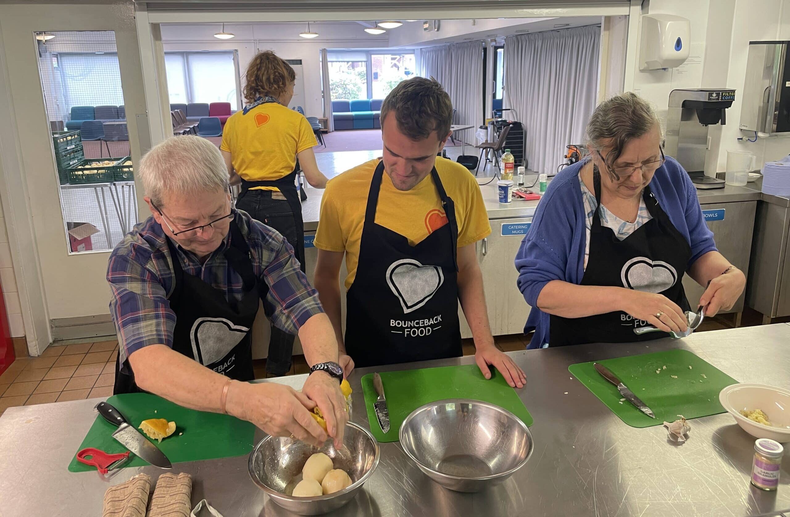 A group of people taking part in a Bounceback Food cookery workshop in a community kitchen